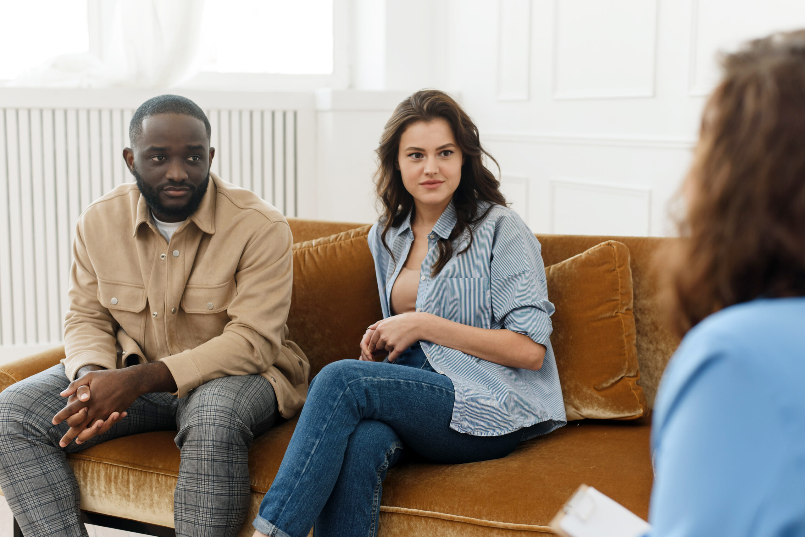 Marriage counseling. Spouses talk to a family psychologist during a meeting after a quarrel, sitting in the office talking about marriage and relationship problems